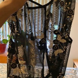 See through sexy top with embroidered flowers. Purchased from a boutique.